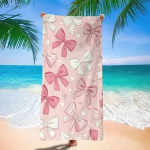 One pink microfiber beach towel with a bow pattern. Breathable, lightweight, absorbent, extra-large size, ultra-soft, microfiber, sand-resistant, and quick-drying. An ideal gift for travel, camping, swimming pools, and summer beaches. A perfect choice for