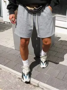 Men’s loose casual shorts with an elastic waistband featuring a drawstring, available in beige; trendy minimalist solid-color design that is comfortable and breathable—ideal for summer wear at home, for sports, or for everyday casual outings.