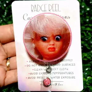 Disgusted Doll Badge Reel BLONDIE Acrylic Design with Glittery Edge and Soft Cloth Cleaning Instructions