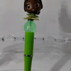 Frog Princess figurine on a green ink pen.