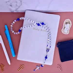Baptized- Frosted glass beads with stainless steel wire for beading and NICKLE and LEAD FREE Crucifix and medallion. The Crucifix has a blue enamel and a St. Benedict medal. Our medallion is Our Lady of Guadalupe with a blue enamel and white rhinestones.