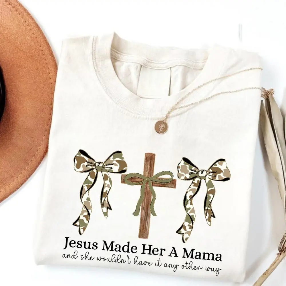 white color Camo Coquette Christian Mama T-shirt, Jesus Made Her A Mama T-shirt, Duck Camo Pattern Shirt, Christian Hunting Camo Mama Shirt