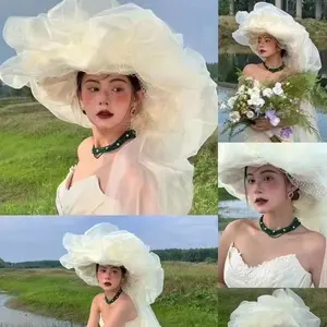French vintage exaggerated high-end tulle cloud fascinator with long veil for travel photography and wedding photography