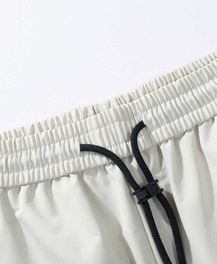 American retro solid color drawstring elastic waist pants with side zipper pockets and rear pocket, adjustable cuffs, ice silk fabric, loose long pants; men’s quick-dry breathable casual pants for everyday wear and outdoor sports; unisex design.