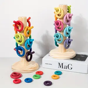 Wooden Toys Including Rainbow Rings, Rainbow Numbers, Tree Macarons, And Color Sorting Display Stands.