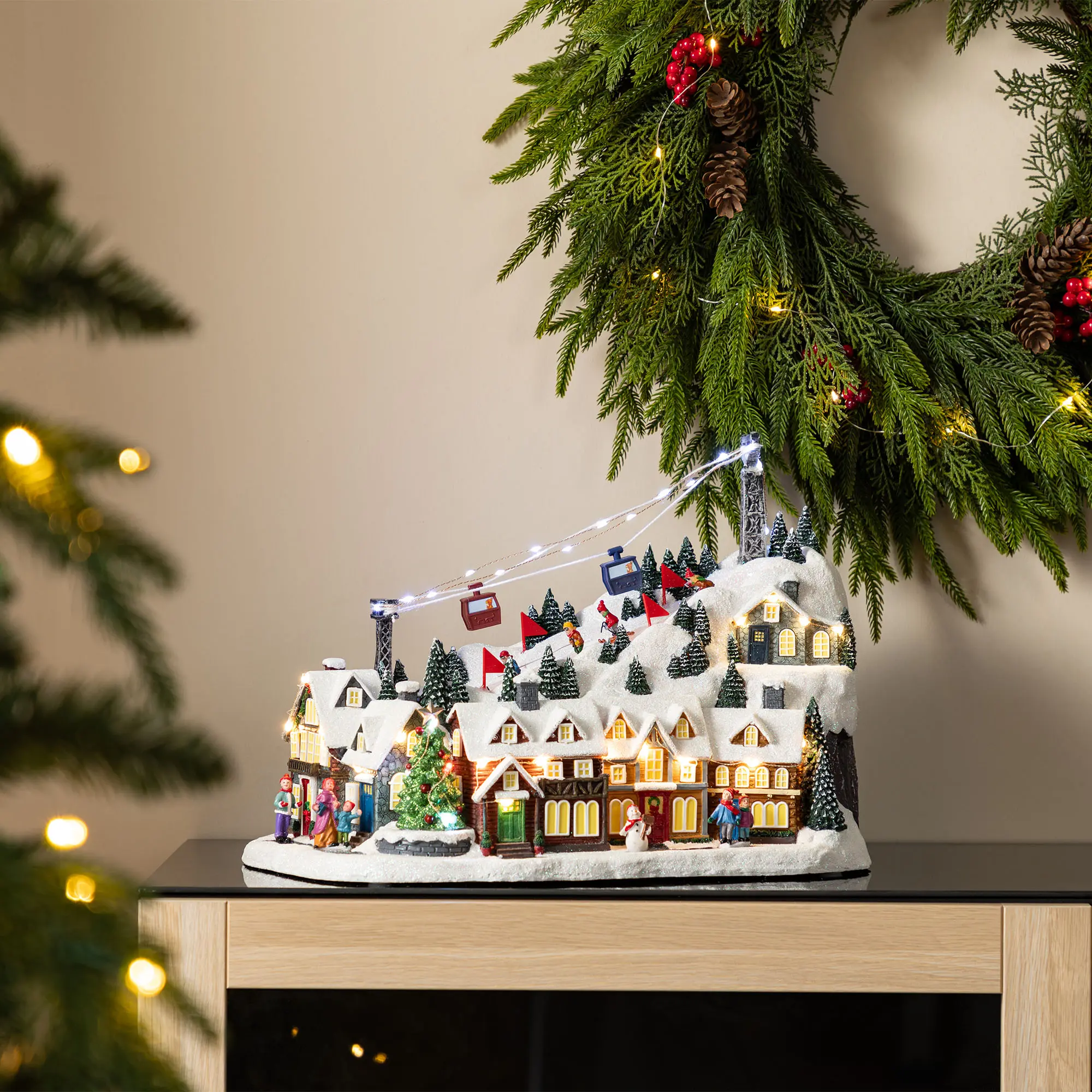 Glitzhome 16"H Christmas Oversized Resin Lighted Musical Skiing Table Village Decor with Timer