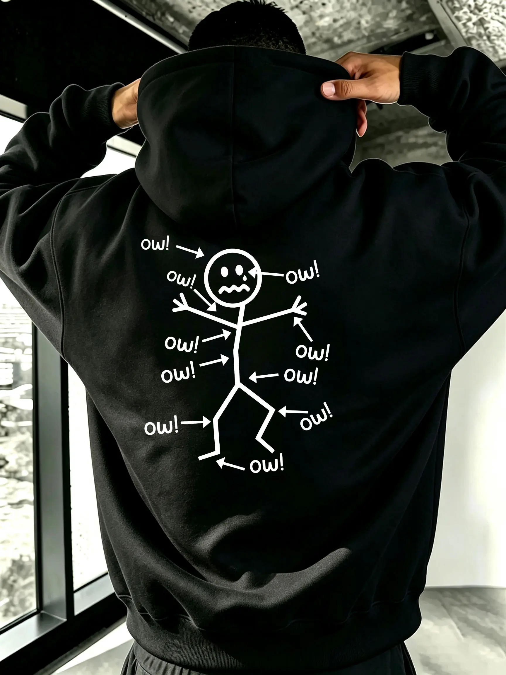 Ouch! Oversized hoodie sweatshirt featuring a back print of a figure experiencing pain all over the body, humorous and quirky meme cartoon illustration, unisex