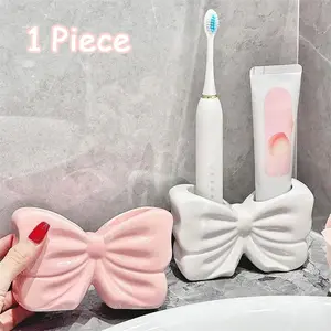 Upgrade Your Bathroom Aesthetic. Pink Bow Ribbed Organizer Toothbrush Holder | Modern Clear Vanity Cup with Silver Feet, Trendy Coquette Room Decor