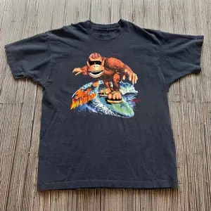 90s Surfing Monkey T-Shirt | Funky Gorilla Surfer Illustration Crewneck | Soft Breathable Black Short Sleeve Shirt | Retro Skate Surf Aesthetic Casual Top