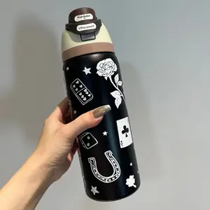 The Owala joint-venture lucky lucky cup features a black body with patterns such as playing cards, stars, and cowboy boots. It is a 32-ounce large capacity water cup made of 304 stainless steel.