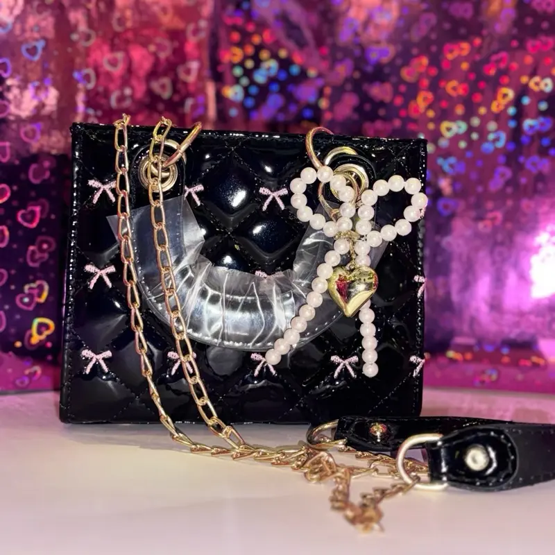 Stylish Leather Crossbody Bag Medium Size Versatile Everyday Luxury with Pearl Bow Charm Gold Chain Strap Shiny Quilted Finish Pink Bow Details