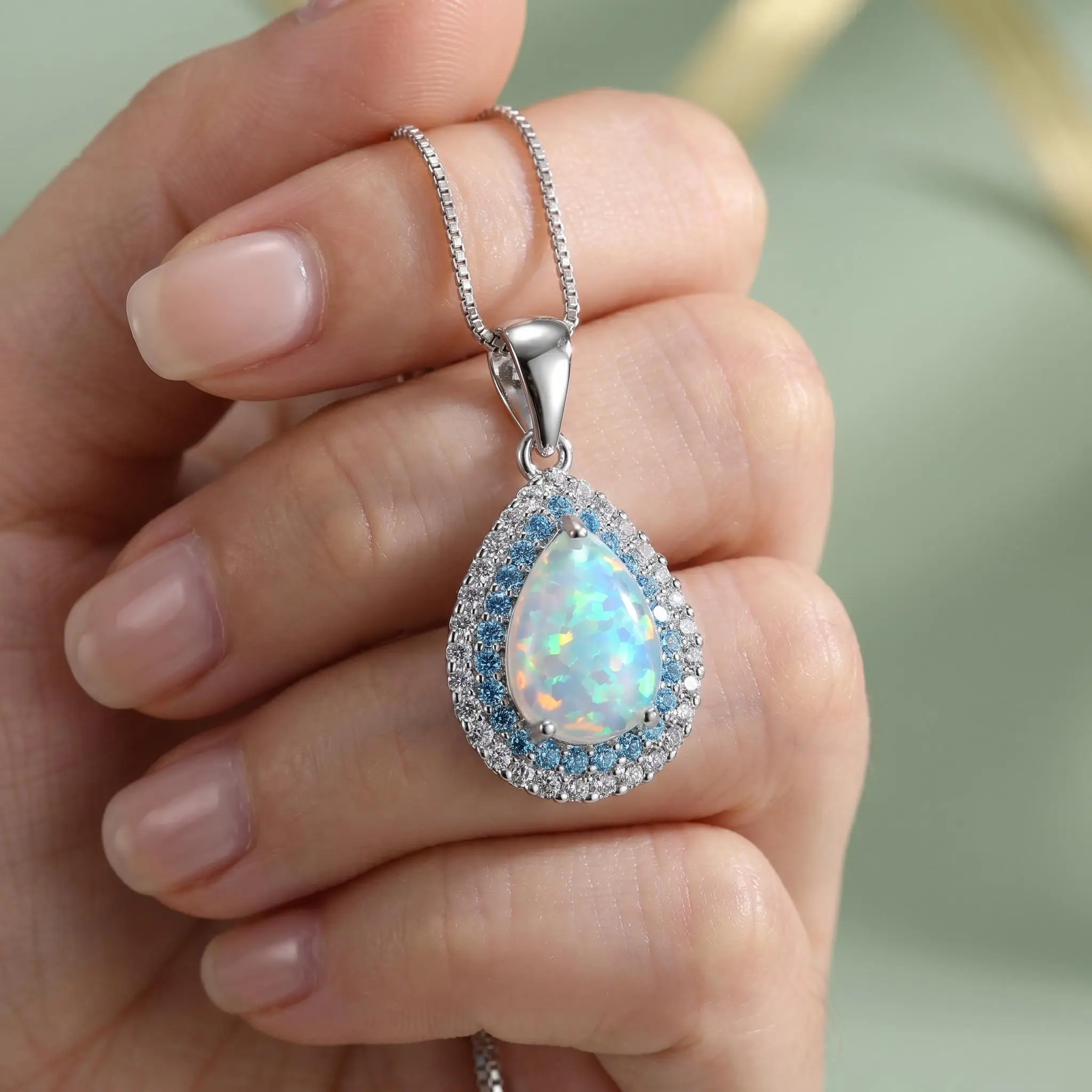 AAA-grade color-changing fire opal teardrop necklace with 925 sterling silver chain and dual aura effect; blue crystal pendant; low allergy risk; high-end jewelry—romantic birthday/anniversary gift for women, mothers, girlfriends, and wives.