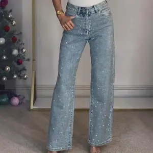 Women’s high-waisted straight washed jeans with full rhinestone embellishments — sexy long pants that can be worn over a raincoat