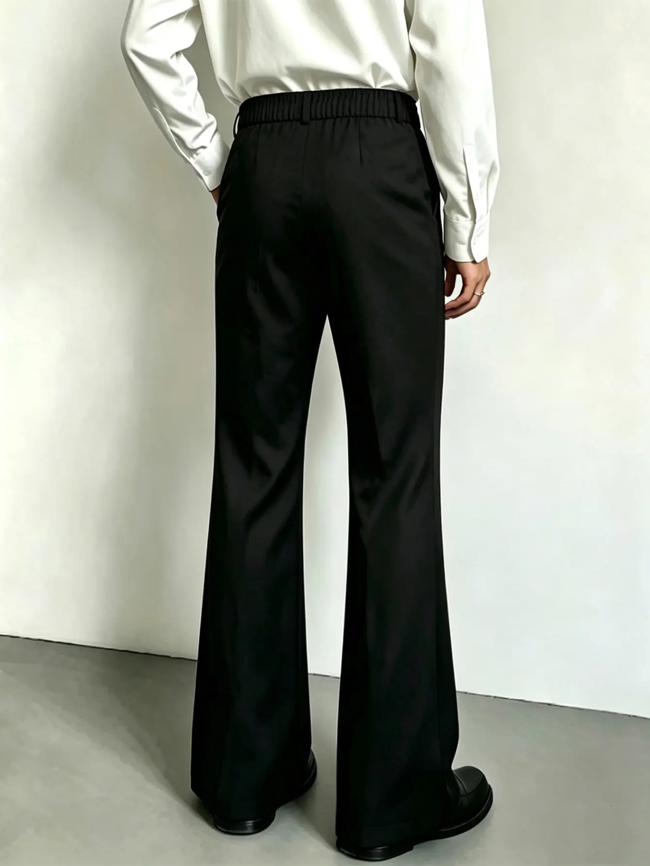 Men’s double button dress pants with a center crease and flared legs – elastic waistband at the back, 3D pressed pleats, drapey wrinkle resistant fabric, bootcut hem, Korean minimalist commuter style for business, dates, and everyday streetwear