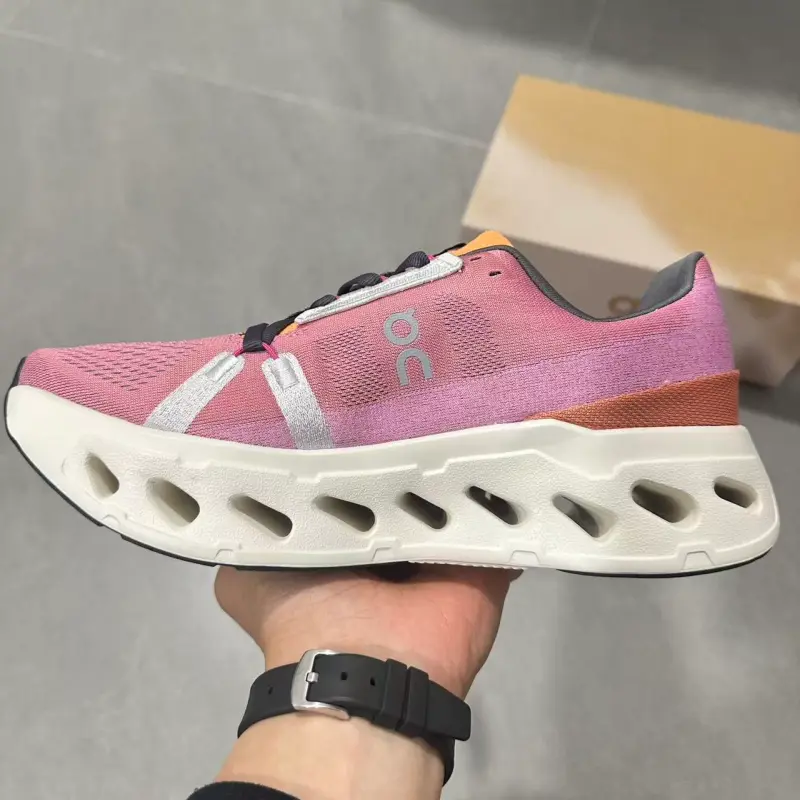 Stretch knit mesh lifestyle running trainers built for lively warm feminine spring summer urban fashion aesthetics, dense gradient pink flexible knit shell layered with vivid orange ankle trim and hollow cream foam cushion layers