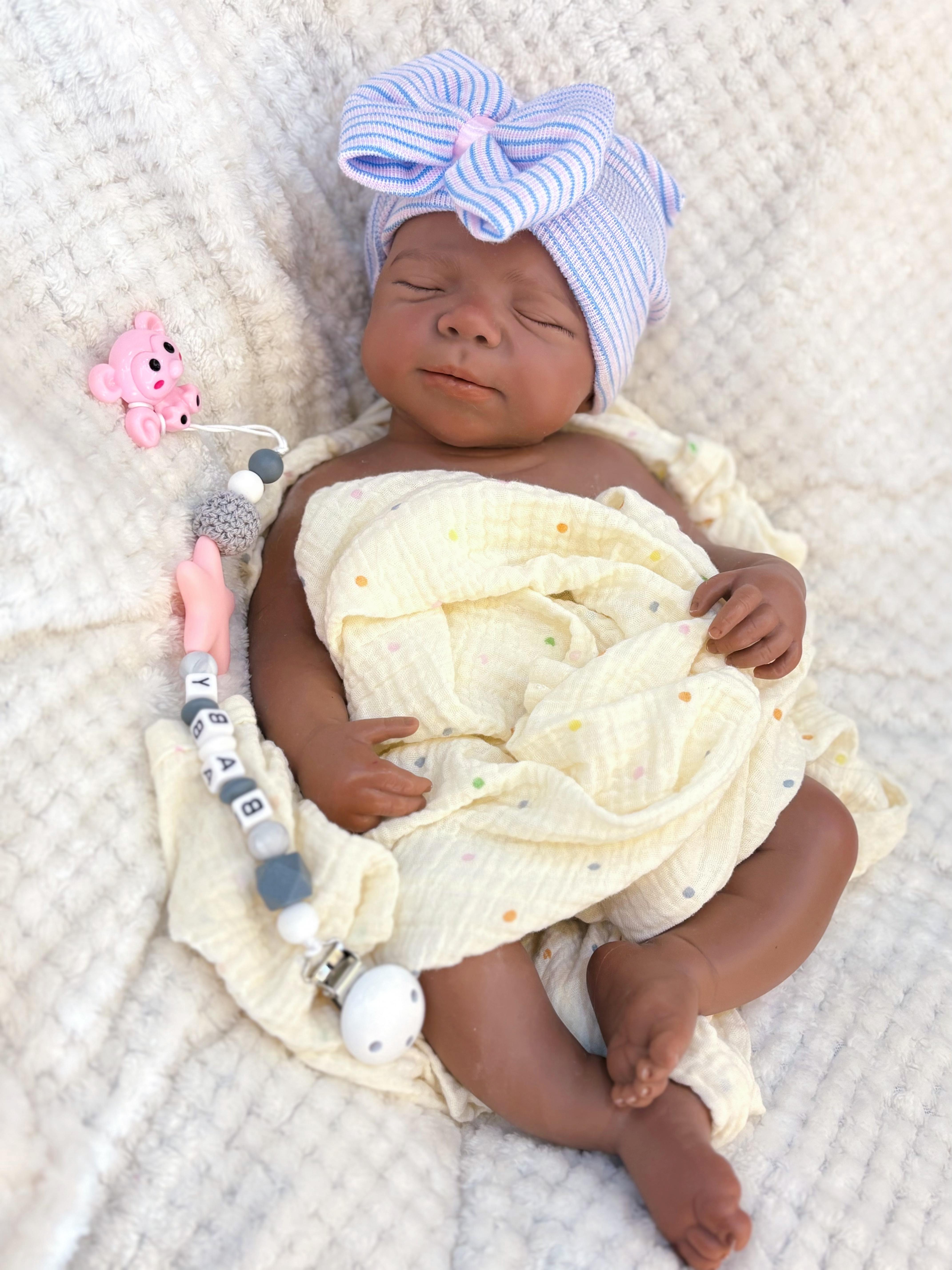 Reborn doll, soft silicone — 18 inches tall, lifelike with closed eyes for sleeping, brown skin, a soft body, and realistic detailed features. Includes a comfort item, a bottle, and a birth certificate. Perfect for birthday gifts, collectors, and children