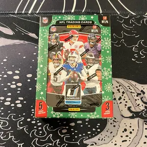 Donruss 2025 Football Holiday Tins Look for Downtowns NFL Trading Cards 5 Cards Per Pack 3 Packs Per Box