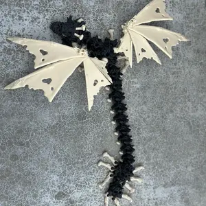 Calacas Winged Skull Dragon articulated flexi figurine! With Bone and black features this skull dragon uses the skulls of his opponents as scales.