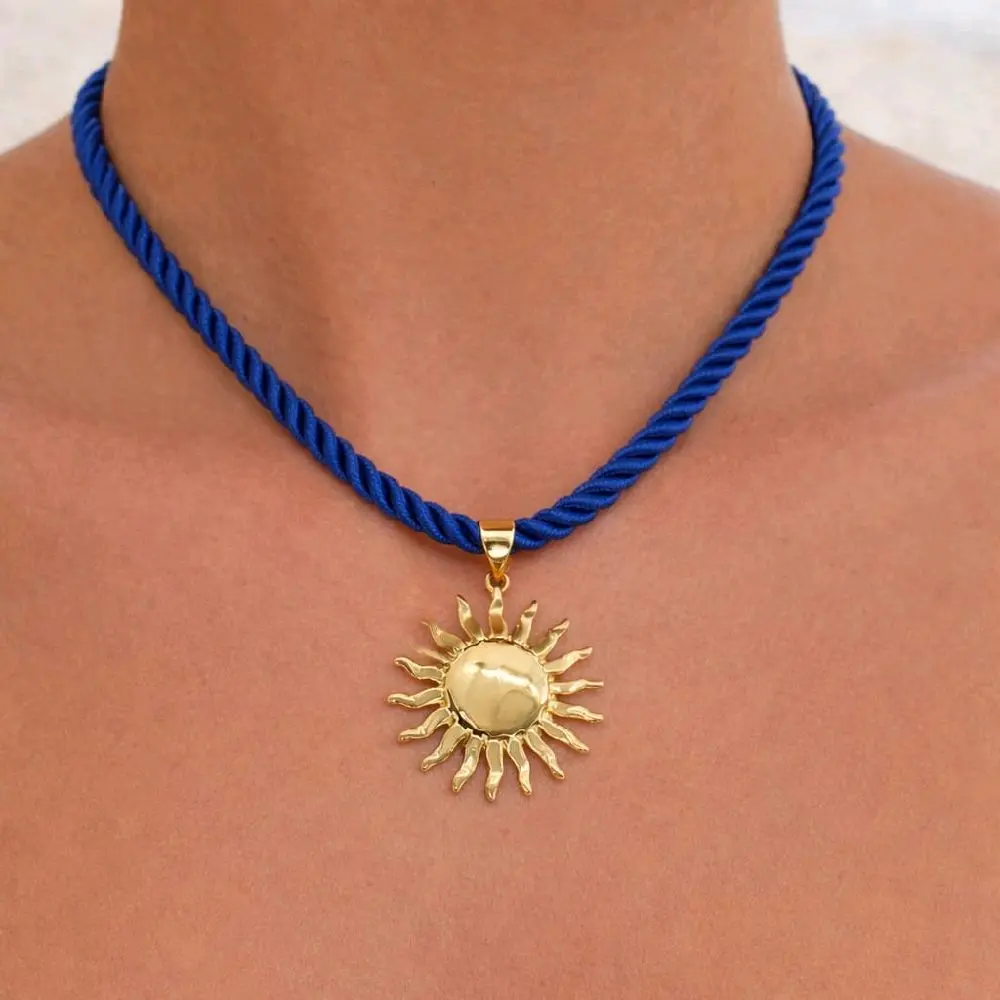 SunWave Necklace . 14K Gold Plated Sun pendant with a Blue thread Cord.