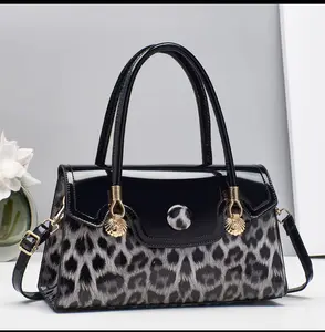 Animal Print Black Bag with Gold Accents and Adjustable Strap for Everyday Use