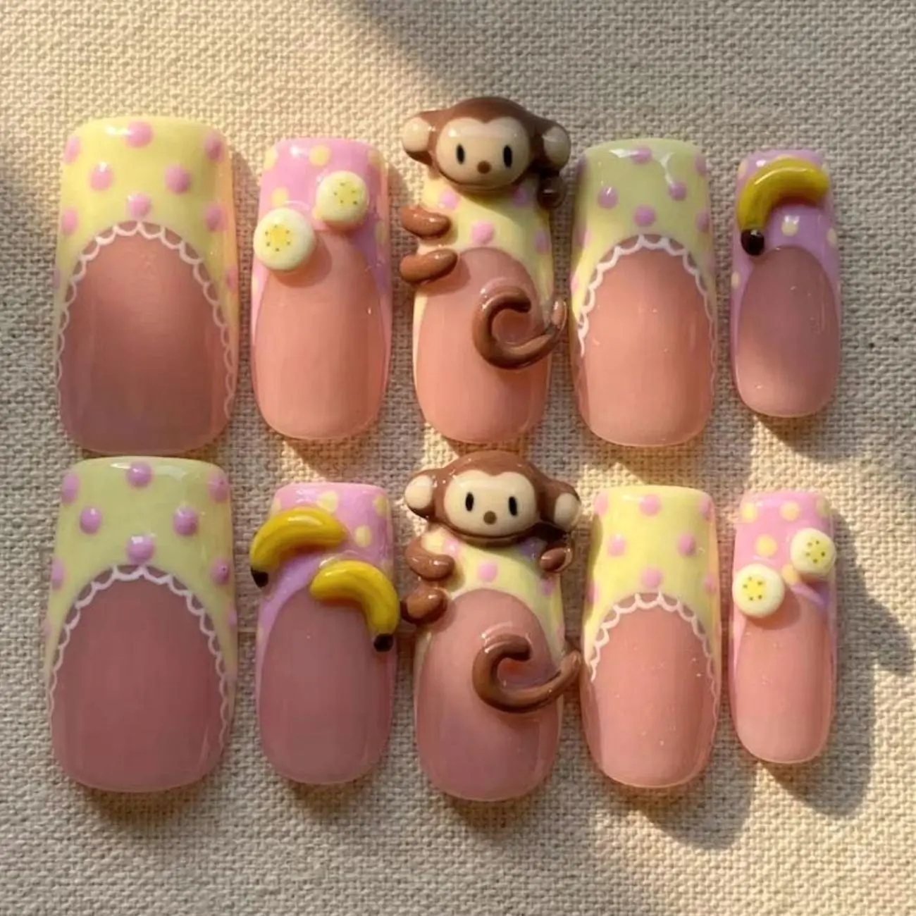 Pastel Monkey Press On Nails, Pink Yellow French Tips, 3D Monkey Charms, Banana Details, Polka Dot Pattern, Playful Tropical Nail Art