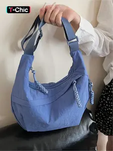 Lightweight and simple pleated nylon crescent bag with woven tassel embellishments. Stylish and versatile crossbody bag for work commutes. Zipper closure. Suitable for commuting, shopping, dates, and everyday accessories. Casual Shoulder Bag