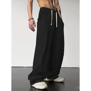 Men’s solid wide-leg sweatpants with pockets and a drawstring waist; street fashion casual loose pants for daily wear; men’s trousers for fall and winter