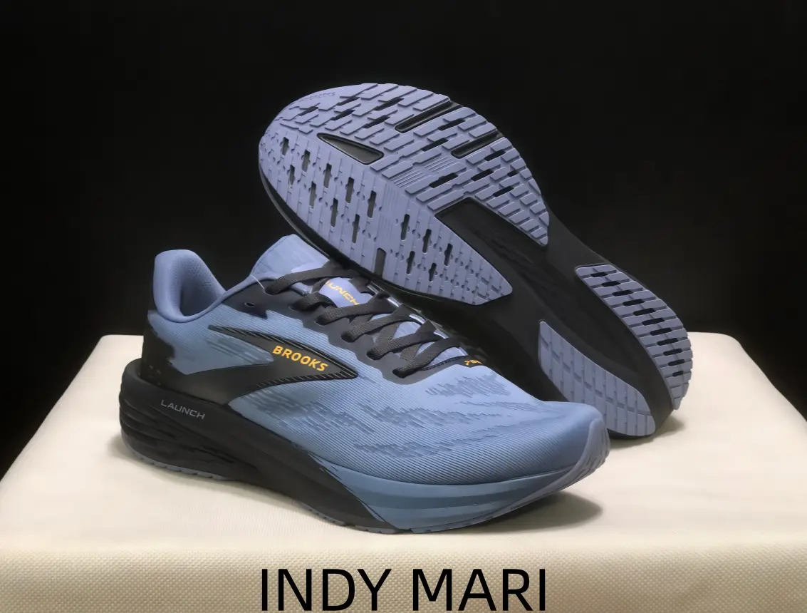 Light sky blue athletic shoes with black graphic details and breathable woven mesh upper, thick foam midsole offers responsive cushion for daily road race training