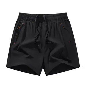Quick-dry shorts with drawstring waistband + side pockets accented by orange piping, perfect for sports and casual wear in various settings.