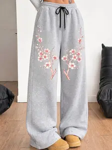 A pair of women's casual trousers with an American-style retro vintage elegant design, featuring a fun gothic dark and sweet-cool vibe, and a unique Japanese-style cherry blossom multi-patterned wide-leg straight-leg pants.