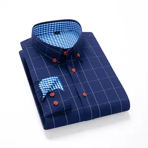 A men’s long-sleeve shirt featuring a plaid color-block design, styled for business casual wear. It has a notched lapel collar that is sharp and well-structured, with red buttons adding a refined touch. The blue-and-white plaid interior provides visual de