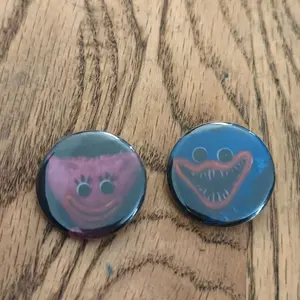 Cartoon Character Badges - 2 Pack, Pink and Blue Design, Round Shape, Ideal for Kids and Fans