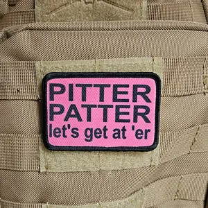 pink and black Pitter patter let's get at 'er 2"x3" morale patch with hook and loop backing