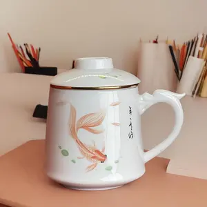 Sheep fat jade ceramic tea-water separation goldfish cup is suitable for family office drinking tea, a filtering tea cup, a mug