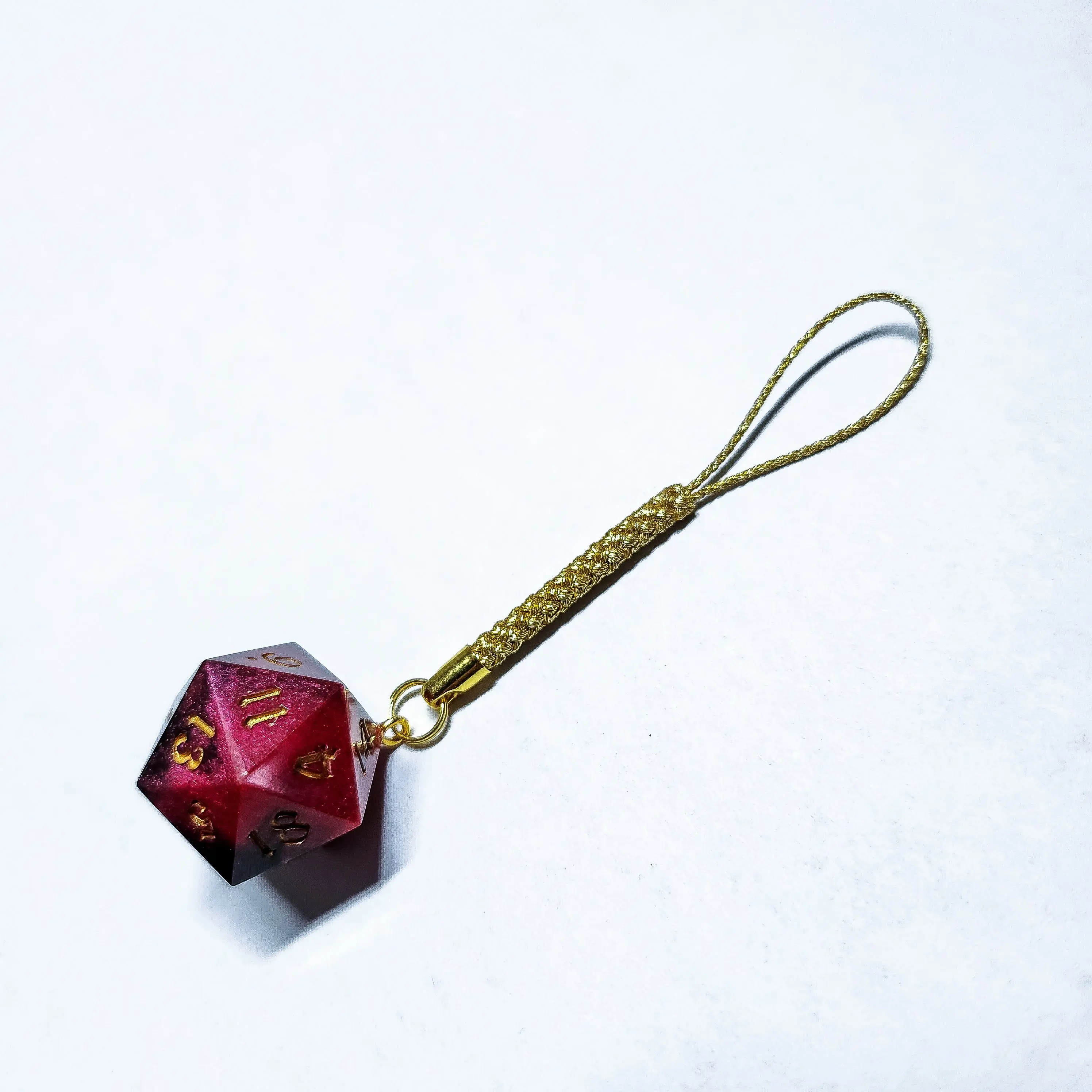 Hand-crafted red and black resin d20 keychain.  Featuring intricate designs inspired by anime, folklore and the world of dungeons & dragons, these keychains are perfect for gamers and fantasy enthusiasts alike.