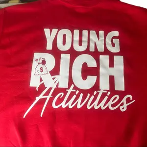 YOUNG RICK ACTIVITIES Red T-Shirt with Graphic Design Featuring Bold Text and Unique Style