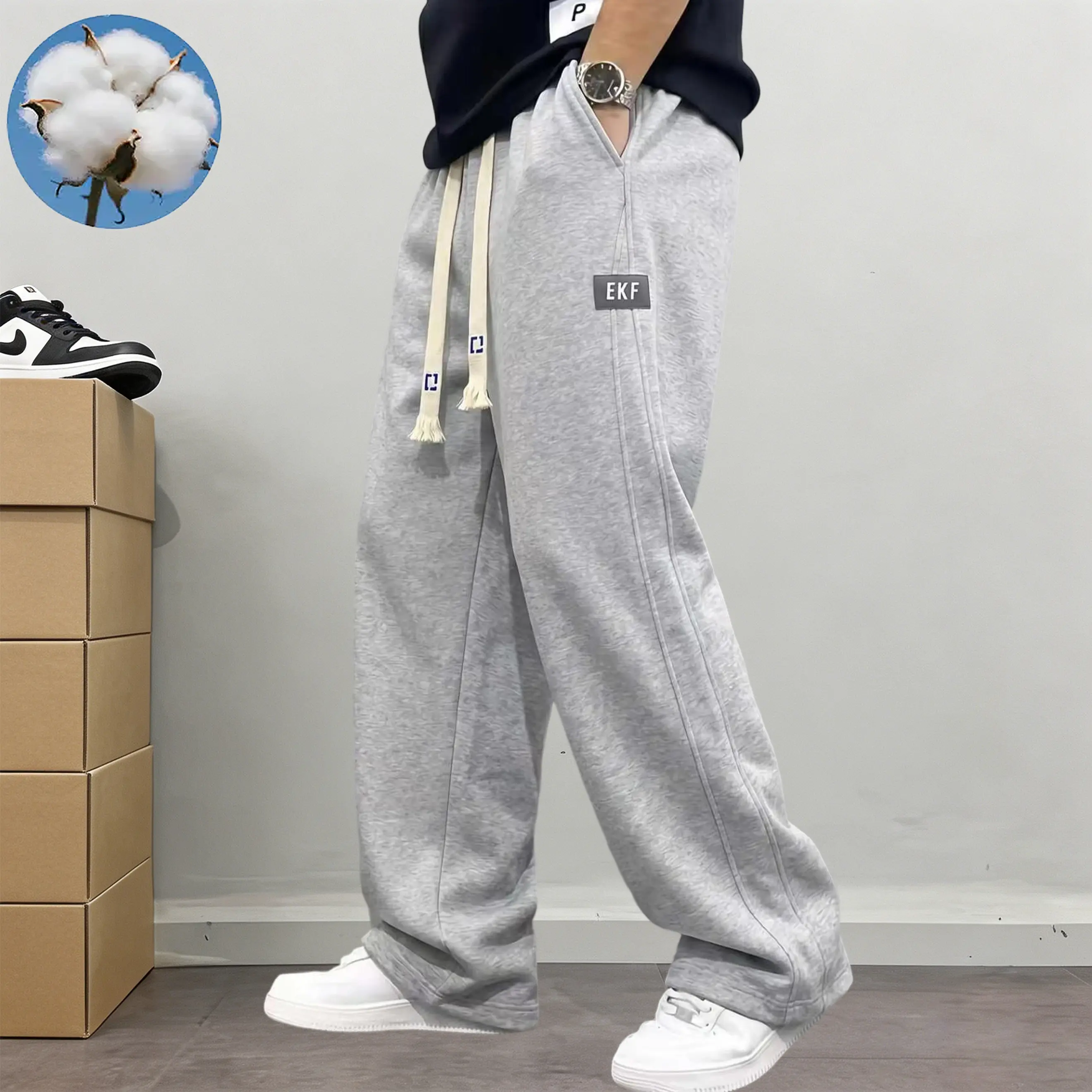 Men’s cotton joggers with a drawstring elastic waistband and wide straight legs; relaxed drop-line cut with practical side pockets; American street style; versatile casual pants for everyday commuting, sports, and streetwear.