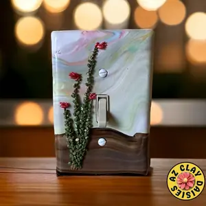 Light switch cover made from polymer clay featuring an ocotillo