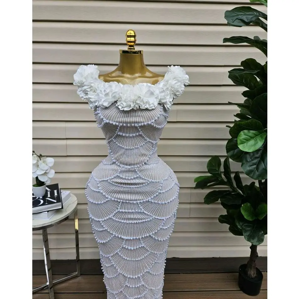 Elegant White Off-Shoulder Dress with Floral Embellishments.