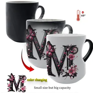 Heat-changing ceramic mug with pink butterfly and floral motif, heart-shaped handle, 11 oz/330 ml capacity. This color-changing thermos is perfect for hot and cold beverages.