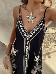 A women's black floral print Boho irregular design V-neck halter loose woven dress with a beachy vibe