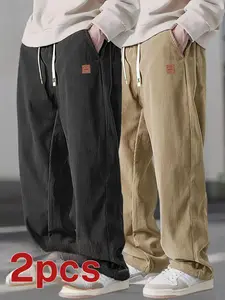 Two men's casual pants featuring a simple and versatile style with drawstring design, adding a casual feel. The pants have delicate small details, making them full of texture. The loose fit provides comfortable and relaxed wear, suitable for everyday outi