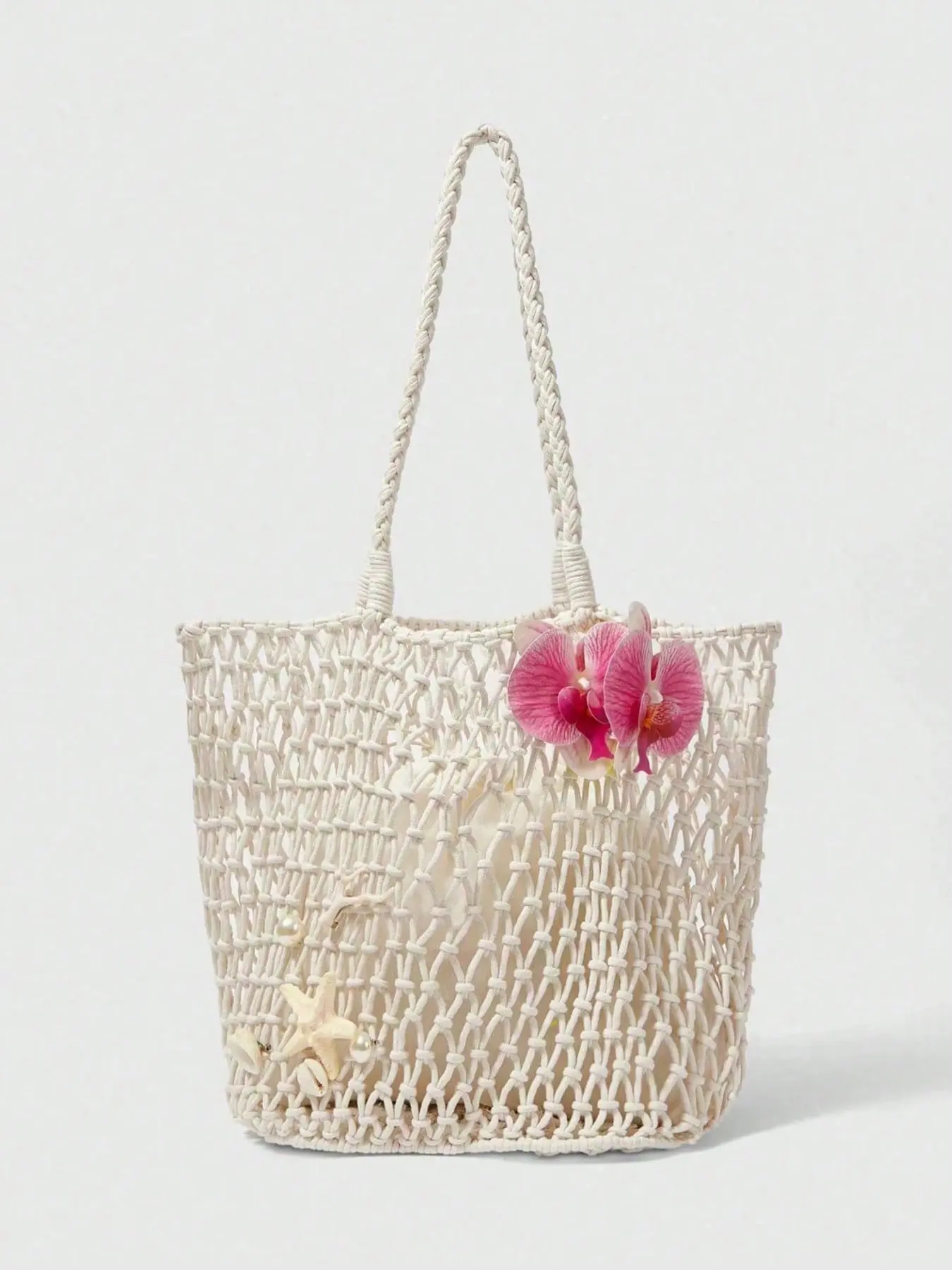 Vacation style hollow tote bag, Woven Bag, handmade knot weaving, decorated with flowers and starfish, loose bag shape, beige color matching, suitable for beach and gentle dressing, enhancing a fresh atmosphere.
