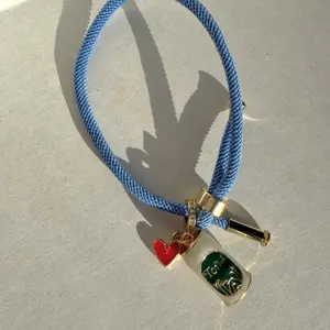 Pulsera Toña y Victoria  Cord Bracelet with Gold Heart Charm and Enamel Tag