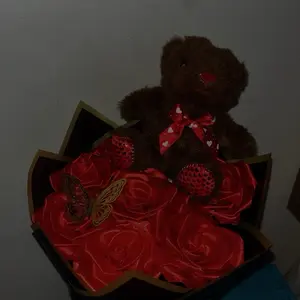 7 count red ribbon bouquet with a butterfly and teddy bear