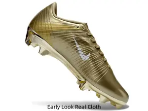 Full metallic gold soccer cleats with silver logo, ultimate champion trophy aesthetic