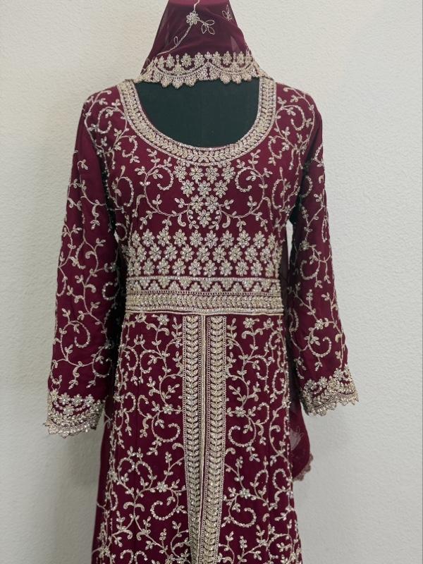 This image shows a green designer heavy embroidered bridal lehenga or Anarkali suit suited for traditional Indian weddings. Womenswear