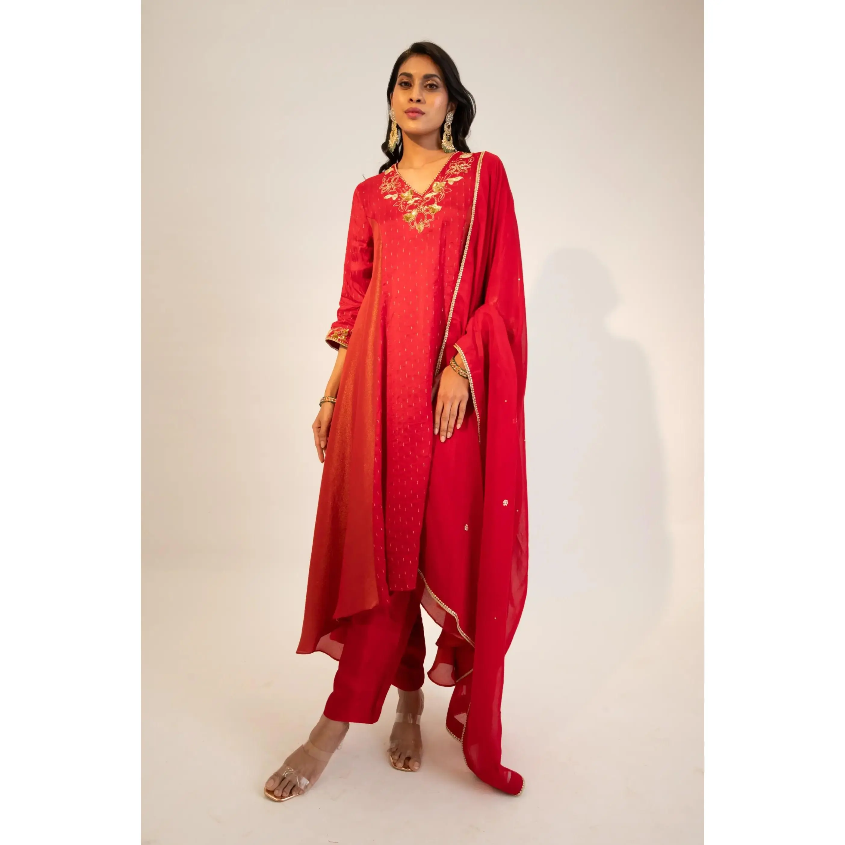 Red embroidered kurta paired with pants and dupatta