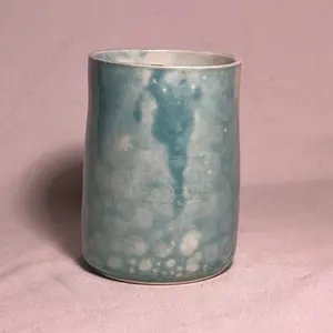 Turquoise blue marbled ceramic cup with bubble texture