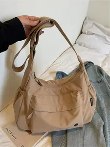 Large capacity fashionable casual shoulder bag with solid color canvas design, simple and comfortable crossbody bag with multiple pockets, niche and versatile armpit bag, outdoor sports shopping commuting bag